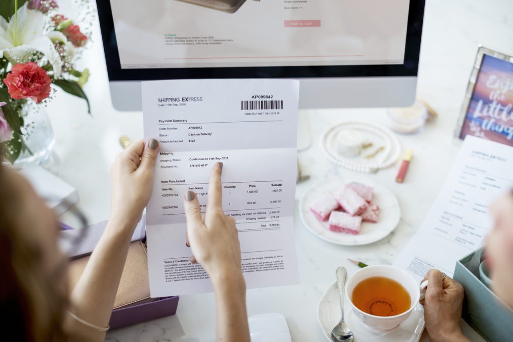 Em seu escritório, empreendedora confere um documento de NFC-e com as novidades para MG e BA